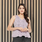 Pink peplum top with black pattern, featuring V-necklines at front and back.